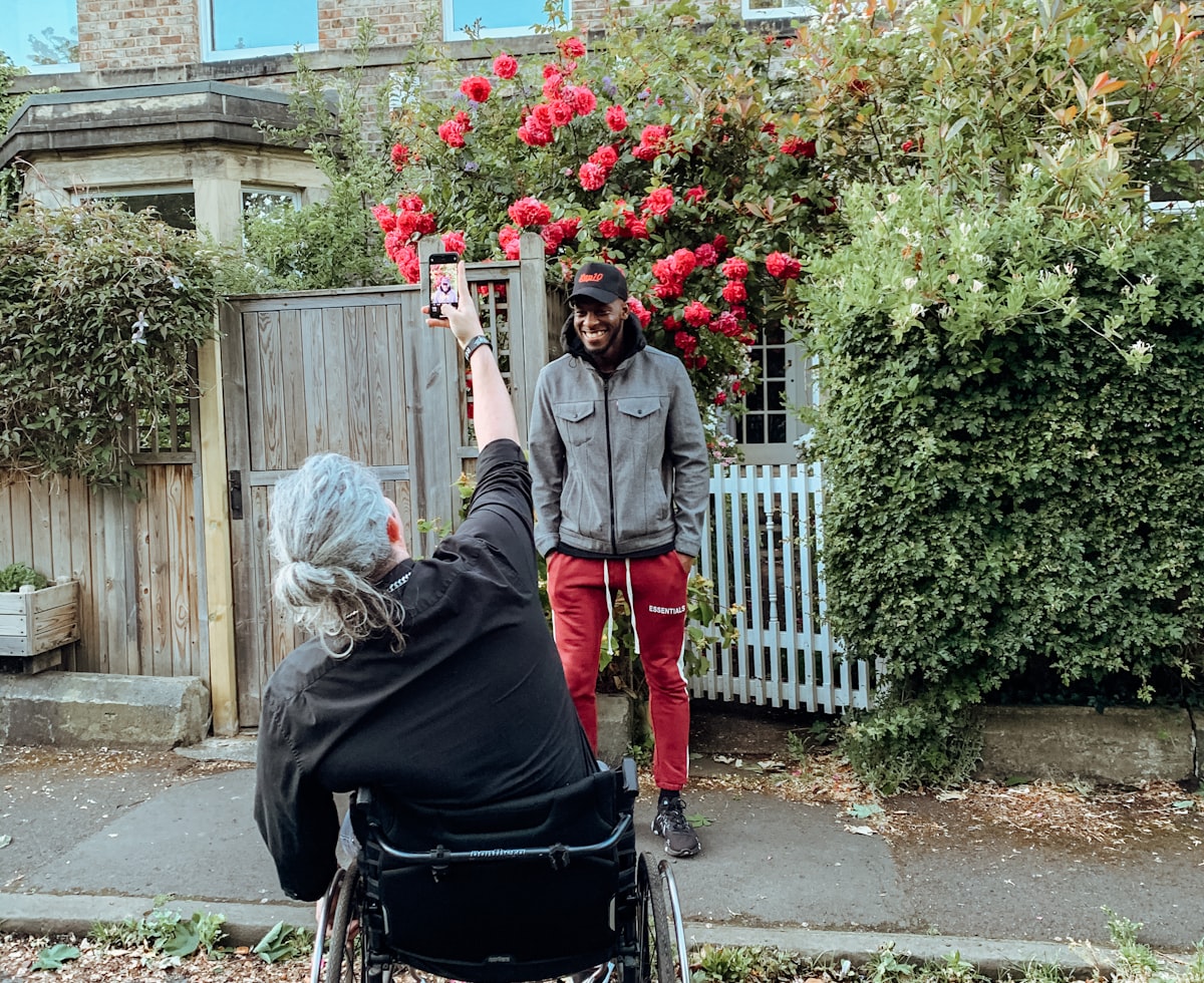 A support worker and participant sharing a warm moment together outdoors
